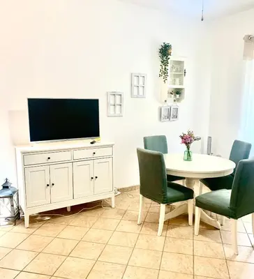 a living room with a tv and a table and chairs at Giava Home in Rome