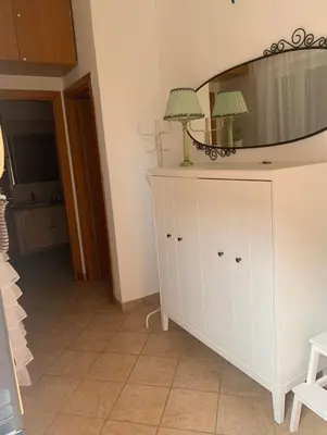 a white dresser with a mirror on top of it at Giava Home in Rome