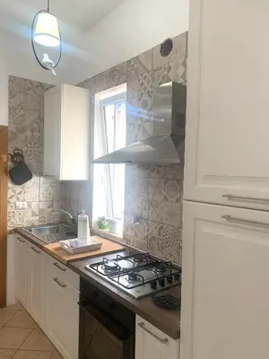 a kitchen with a stove top oven next to a window at Giava Home in Rome