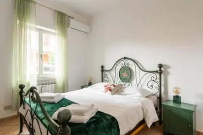 a bedroom with a large bed and a window at Giava Home in Rome