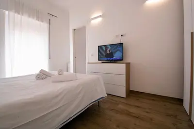a bedroom with a bed and a tv on a wall at Salotti 15 in Rome