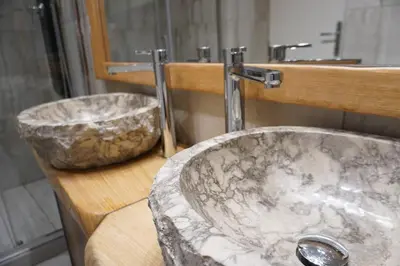 a bathroom with a marble sink and a mirror at Penna Relais al Corso in Rome