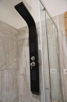 a shower with a black shower head in a bathroom at Penna Relais al Corso in Rome