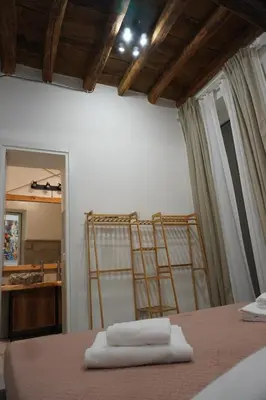 a bedroom with two towels on a bed with a mirror at Penna Relais al Corso in Rome