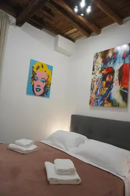 a bedroom with a bed with two towels on it at Penna Relais al Corso in Rome