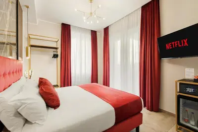 a hotel room with a bed and a tv at AlbaDea Déco&Jacuzzi in Rome
