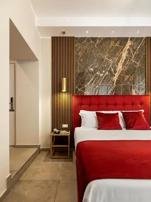 a bedroom with a red bed with a red headboard at AlbaDea Déco&Jacuzzi in Rome