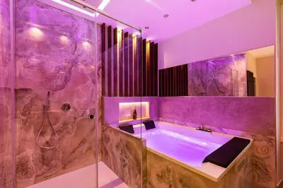 a purple bathroom with a tub and a shower at AlbaDea Déco&Jacuzzi in Rome