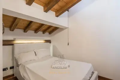 a white bed in a room with a ceiling at Apartment by The Spanish Steps in Rome