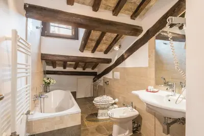 a bathroom with a tub and a toilet and a sink at Apartment by The Spanish Steps in Rome