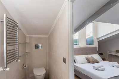 a bathroom with two beds and a toilet in a room at The Best Rent - Apartment near Castel Sant'Angelo in Rome