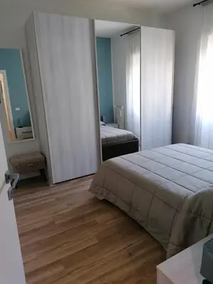 a bedroom with a large bed and a mirror at Capitale Bullicante in Rome