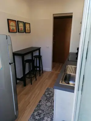 a kitchen with a sink and a table in a room at Capitale Bullicante in Rome