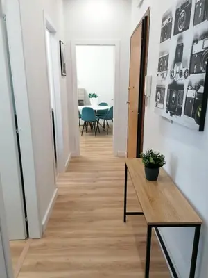 a hallway with a table and a dining room at Capitale Bullicante in Rome