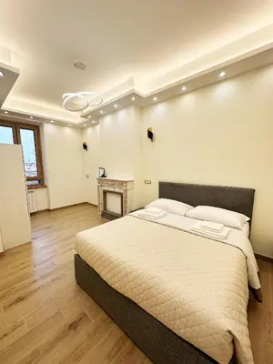 a bedroom with a large bed and a table at ZEUS GROUP VATICAN in Rome