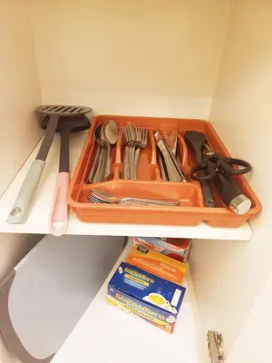 an orange tray with utensils on a shelf at ZEUS GROUP VATICAN in Rome