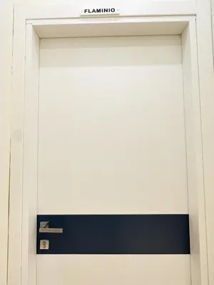 a white garage door with a sign on it at ZEUS GROUP VATICAN in Rome