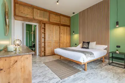 a bedroom with a bed and green walls at Viola Penthouse with Rome Panoramic View in Rome