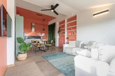 a living room with red walls and white furniture at Viola Penthouse with Rome Panoramic View in Rome