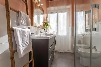 a bathroom with a sink and a toilet and a shower at Viola Penthouse with Rome Panoramic View in Rome