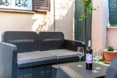 a bottle of wine and two glasses on a table at The vatican garden in Rome