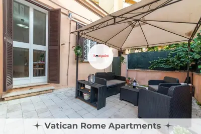 a patio with an umbrella and a table and chairs at The vatican garden in Rome