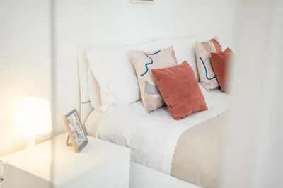 a white couch with pillows on it in a room at The vatican garden in Rome