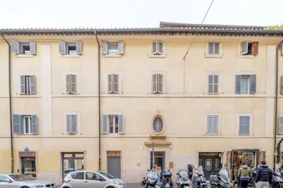 a large building with motorcycles parked in front of it at ht bilo colosseo in Rome