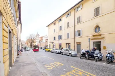 a street with parked cars and motorcycles on a city street at ht bilo colosseo in Rome
