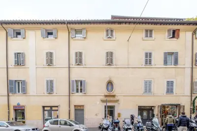 a large building with motorcycles parked in front of it at HT BILO 2 COLOSSEO in Rome