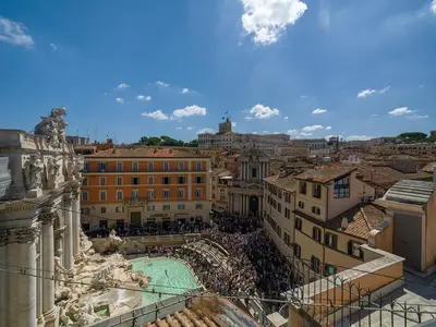 a crowd of people standing around a pool in a city at LUXURY Terrazza Privata su Fontana di Trevi in Rome