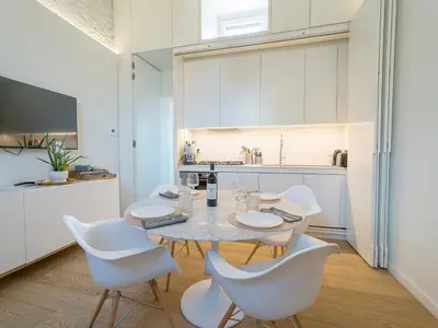 a dining room with a table and white chairs at LUXURY Terrazza Privata su Fontana di Trevi in Rome