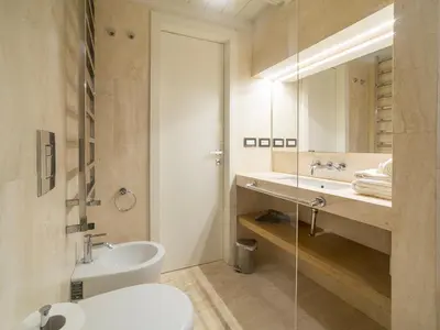 a bathroom with a sink and a toilet and a mirror at LUXURY Terrazza Privata su Fontana di Trevi in Rome