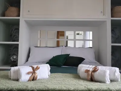 a bedroom with a bed with towels on a rug at La Casa nel Parco - Stadio Olimpico, Auditorium con posto auto in Rome