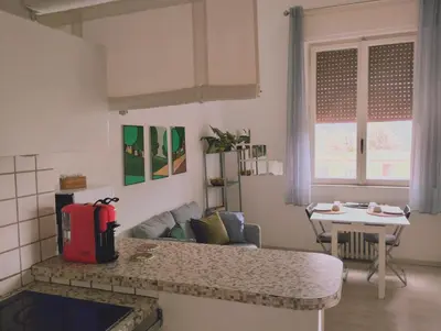 a small kitchen and living room with a table at La Casa nel Parco - Stadio Olimpico, Auditorium con posto auto in Rome