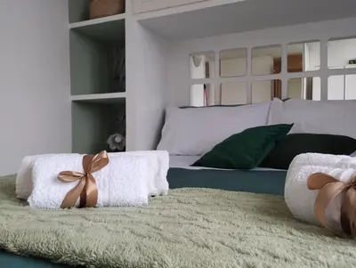 a bedroom with a bed with towels on a rug at La Casa nel Parco - Stadio Olimpico, Auditorium con posto auto in Rome