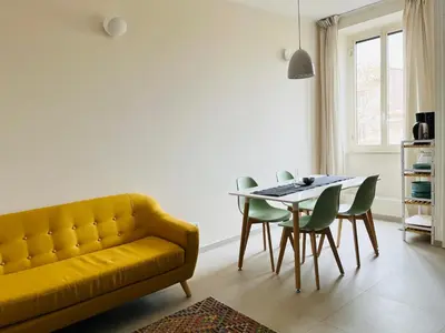 a living room with a yellow couch and a table at Casa Duci in Rome