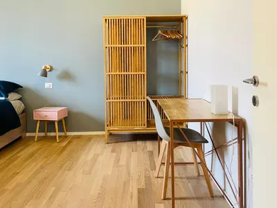 a room with a desk and a bedroom with a bed at Casa Duci in Rome