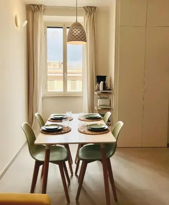 a table and chairs in a room with a window at Casa Duci in Rome