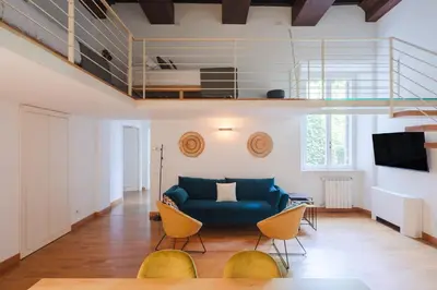 a living room with a blue couch and chairs at Elegant apartment with patio at Piazza Navona in Rome