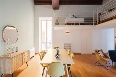 a dining room with a table and chairs at Elegant apartment with patio at Piazza Navona in Rome