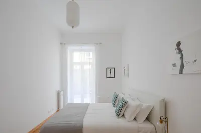 a white bedroom with a bed with pillows on it at Elegant apartment with patio at Piazza Navona in Rome