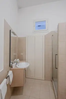 a bathroom with a sink and a shower at Elegant apartment with patio at Piazza Navona in Rome
