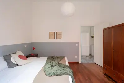 a bedroom with a bed with a green blanket on it at Nuovo appartamento a S. Lorenzo con 3 camere in Rome