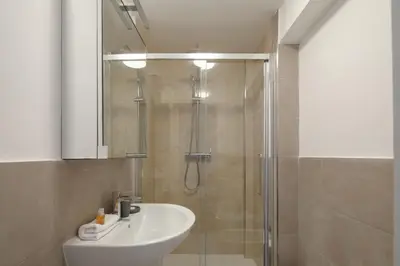 a bathroom with a shower and a white sink at Nuovo appartamento a S. Lorenzo con 3 camere in Rome
