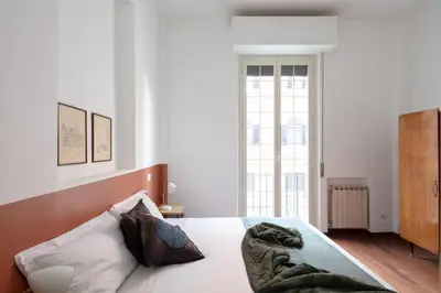 a bedroom with a bed with a blanket on it at Nuovo appartamento a S. Lorenzo con 3 camere in Rome