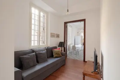 a living room with a couch and a television at Nuovo appartamento a S. Lorenzo con 3 camere in Rome
