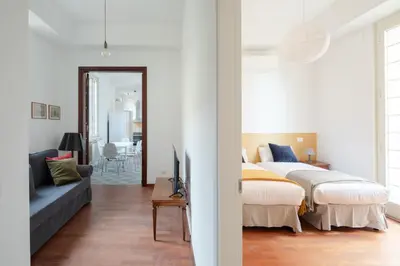 a bedroom with a bed and a living room at Nuovo appartamento a S. Lorenzo con 3 camere in Rome