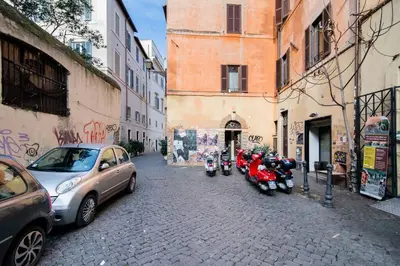 a group of motorcycles parked on a street next to buildings at Brightful Boutique Apartment in the Heart of Trastevere in Rome