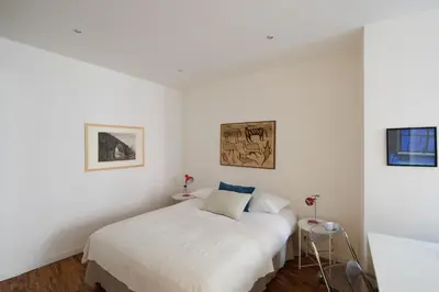 a white bedroom with a bed in a room at Modern pied a terre near Piazza Navona in Rome